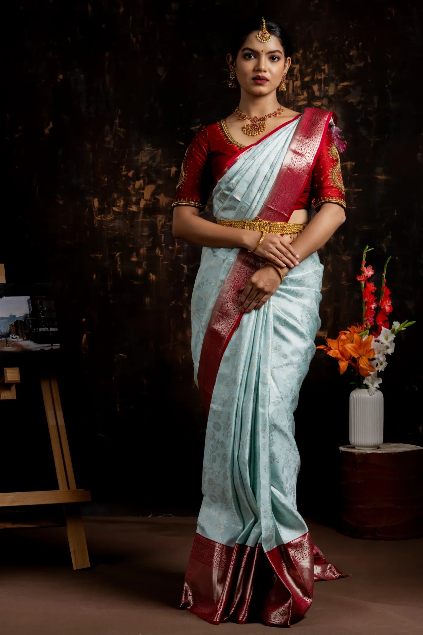 Shrivvi Sky Blue Silk Saree With Floral Work & Red Border